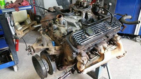 Chevy 350 small-block V8 on an engine stand in the shop during a rebuild